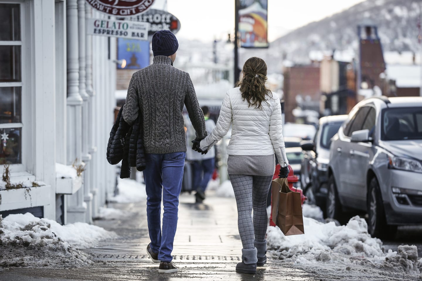 Couple holding hands on Main Street.