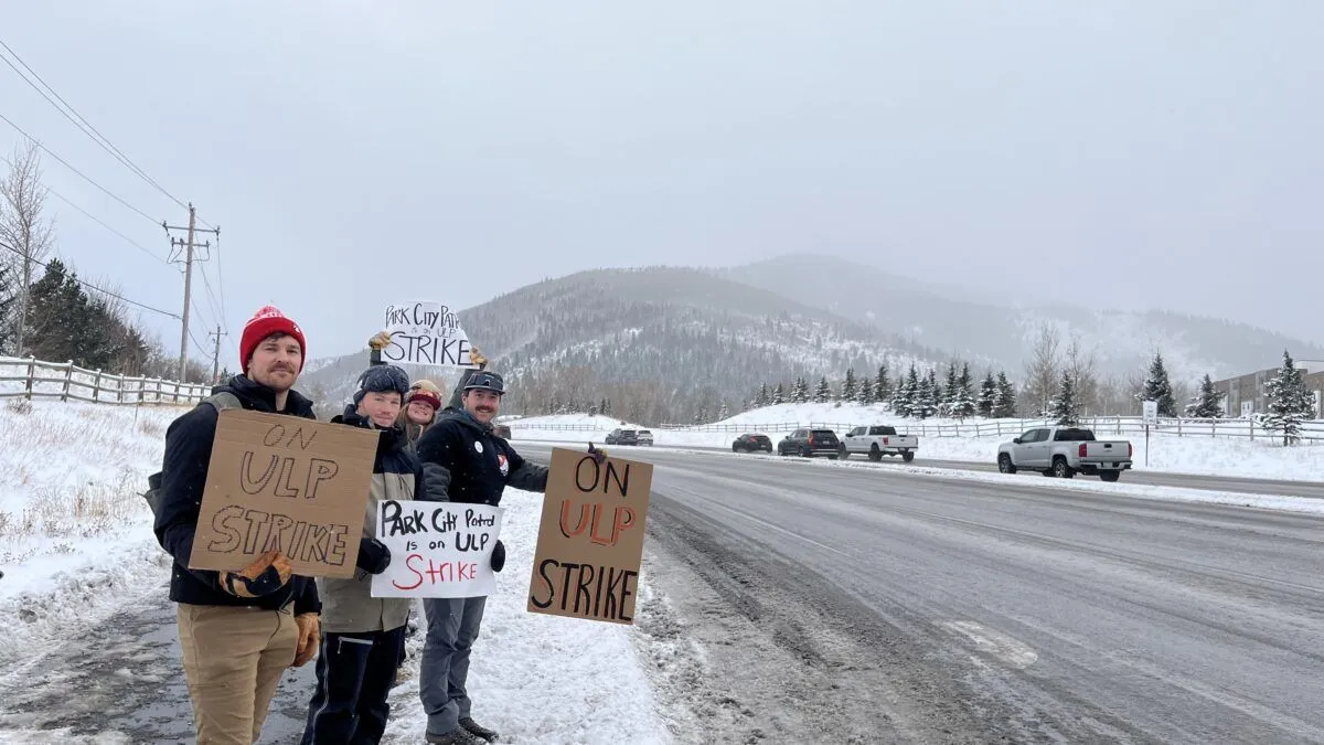 Park City Mountain ski patrollers form a picket line during their strike at Canyons Village, drawing attention to ongoing labor negotiations.