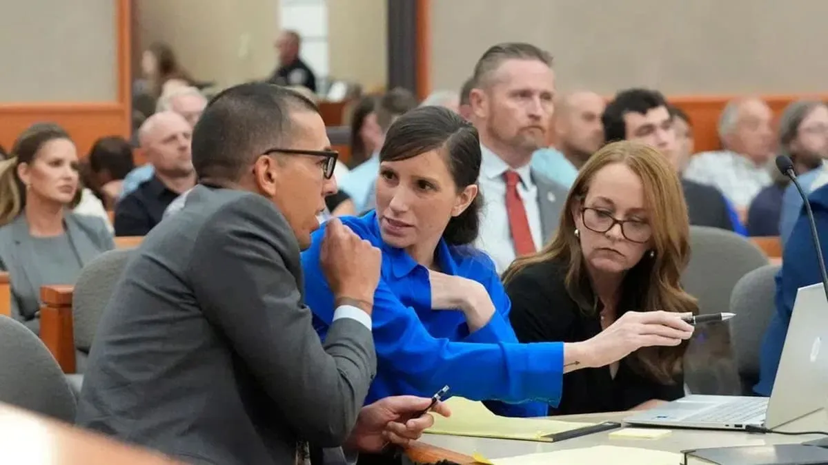Kouri Richins, center, mother of three who wrote a children's book about coping with grief after her husband's death and was later accused of fatally poisoning him, looks on during a court hearing Tuesday, Aug. 27, 2024, in Park City, Utah.