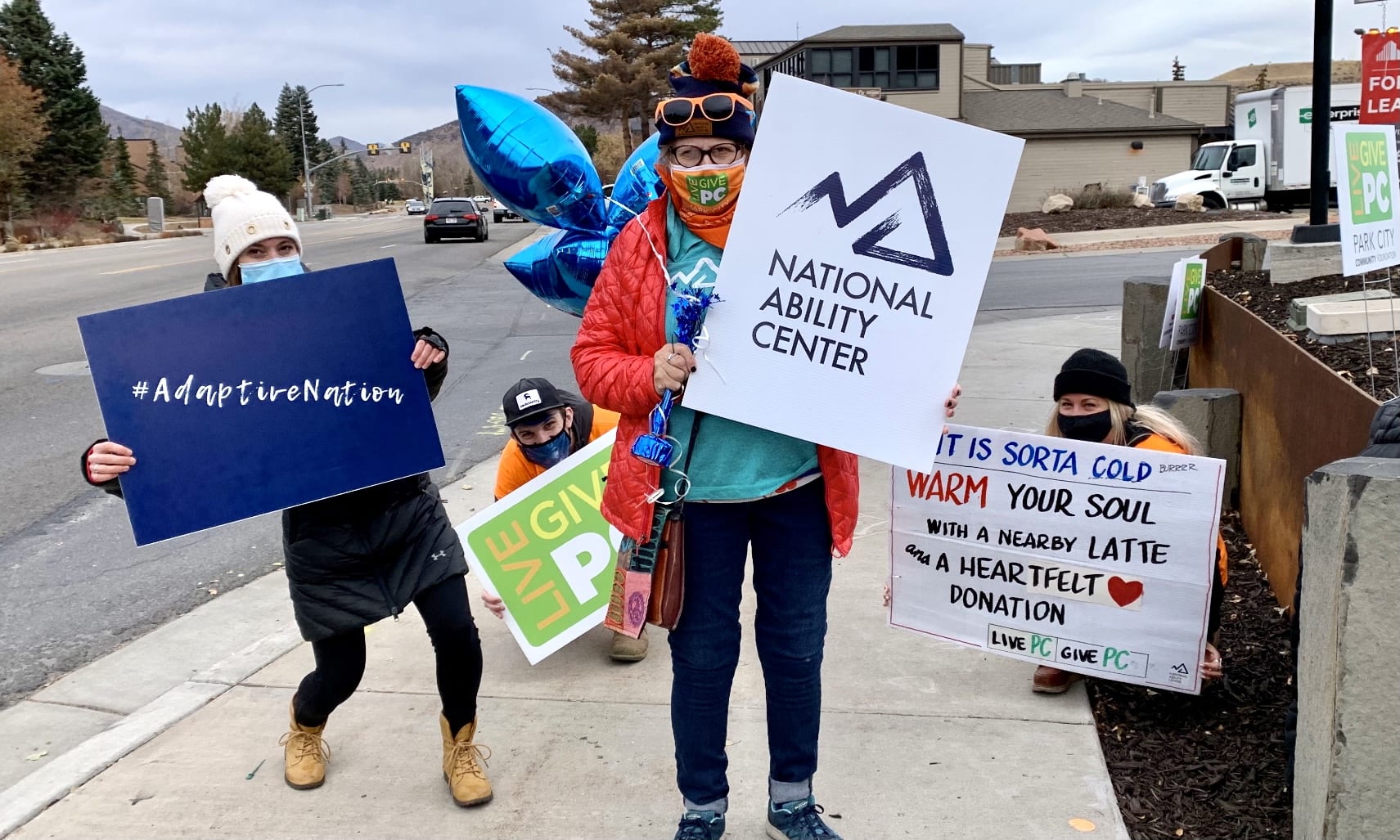 National Ability Center supporters waving signs during Live PC, Give PC 2020.