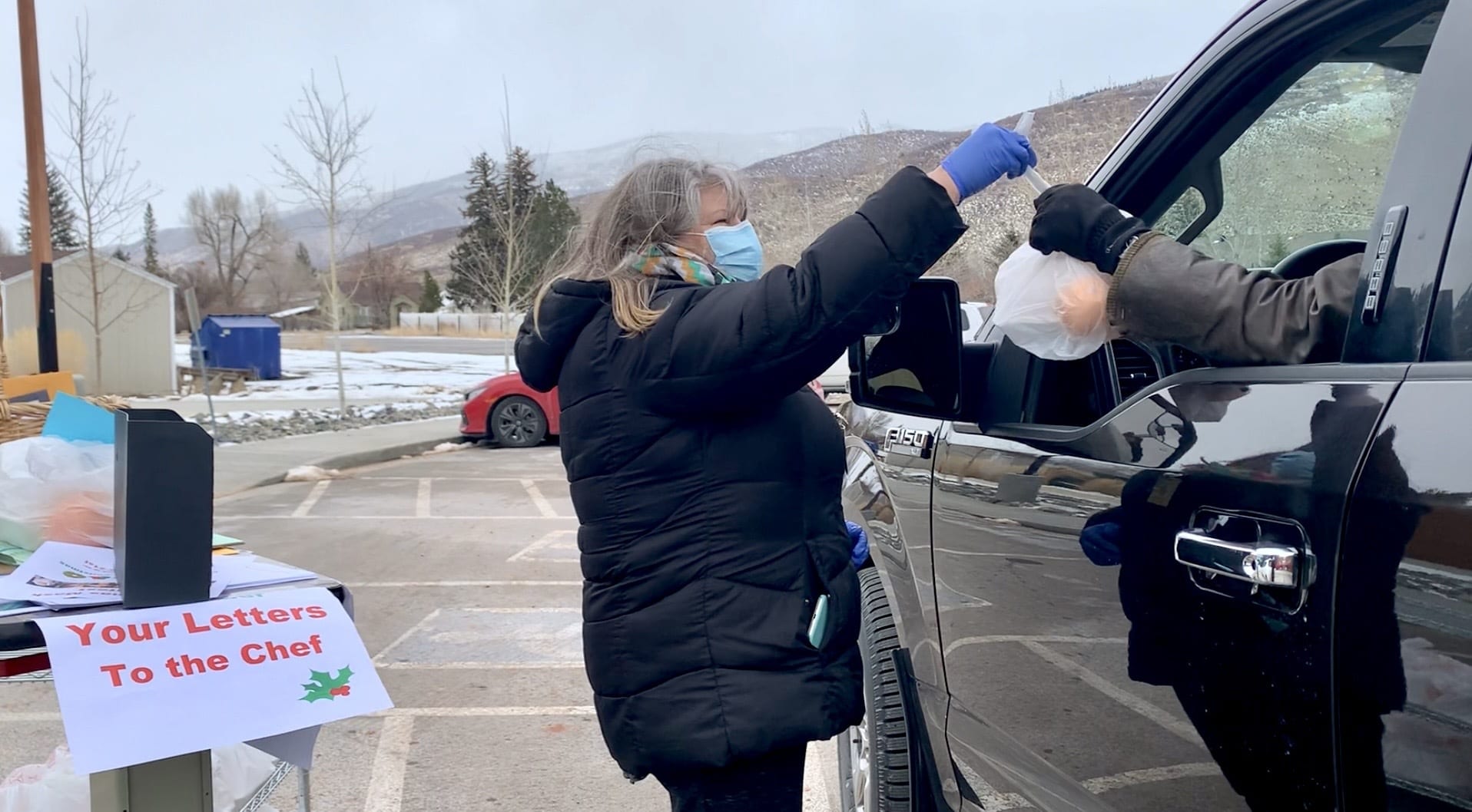 Annette Rockwood, Summit County Senior Center secretary, passes out food Dec. 17 at the South Summit Senior Center in Kamas.