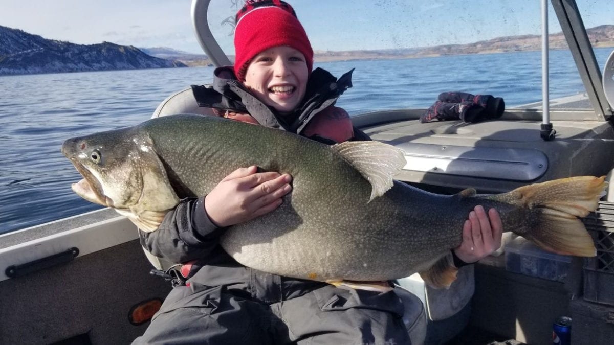 Tyler Grimshaw, 11, holding a 48-pound lake trout he caught at Flaming Gorge