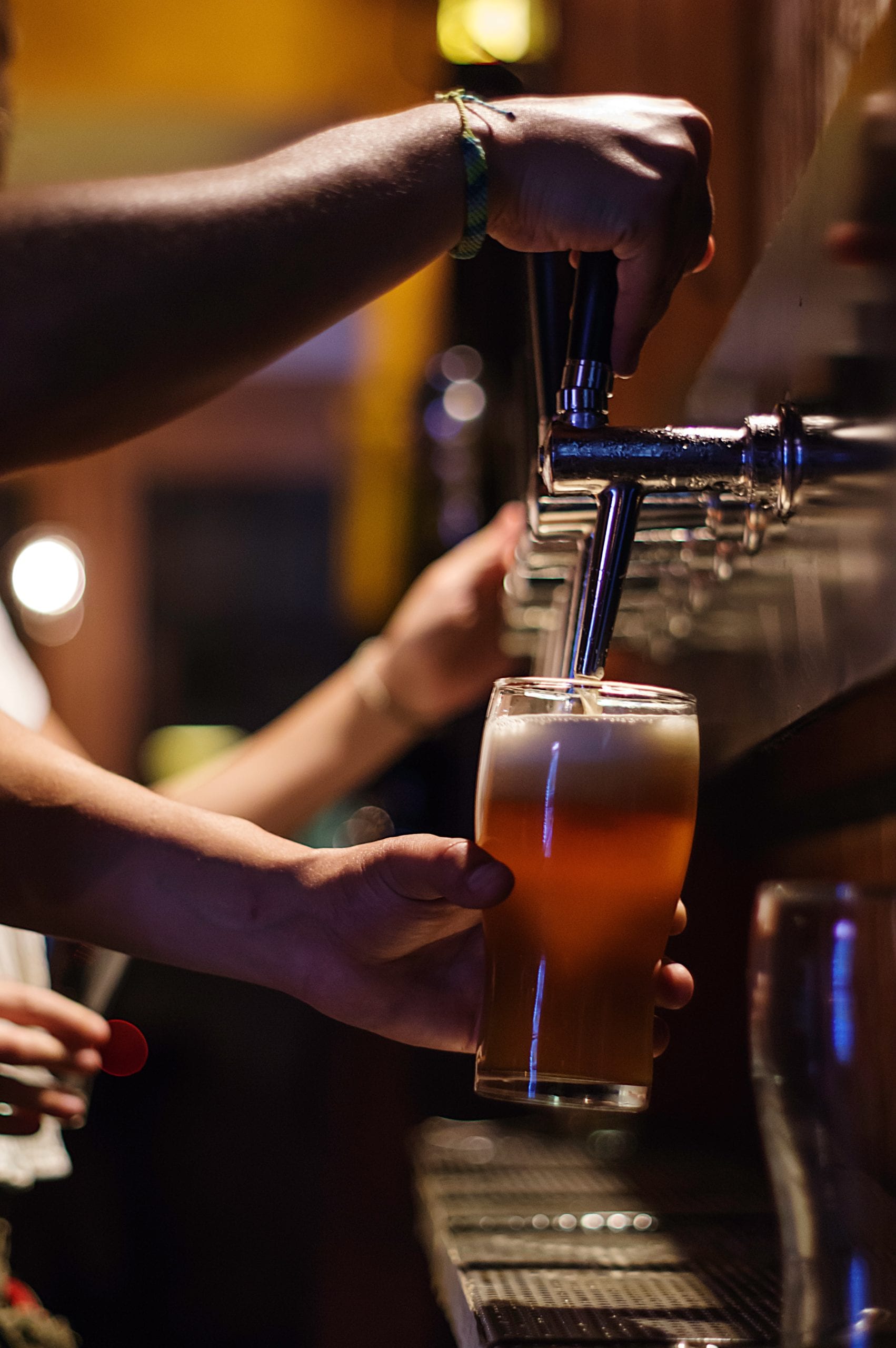 Alcohol being served at a bar.