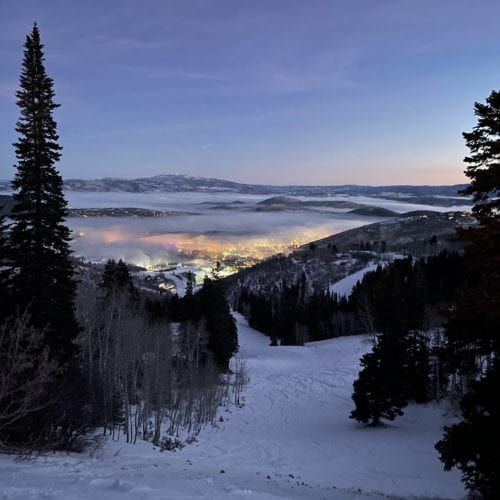 The morning light pouring out over the layer of inversion at the Park City Mountain Resort base area.