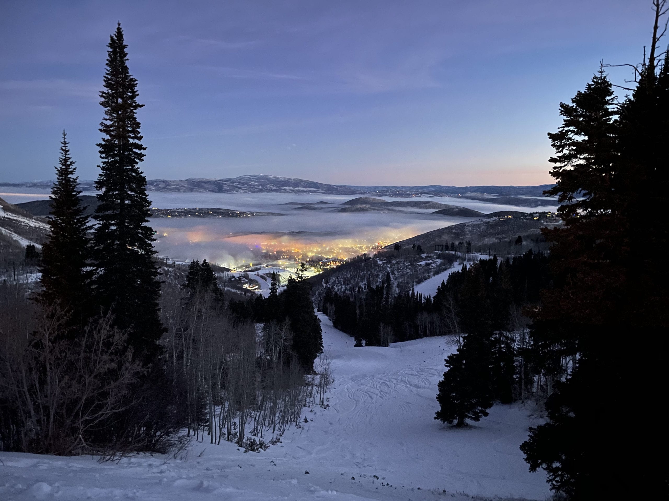 The morning light pouring out over the layer of inversion at the Park City Mountain Resort base area.