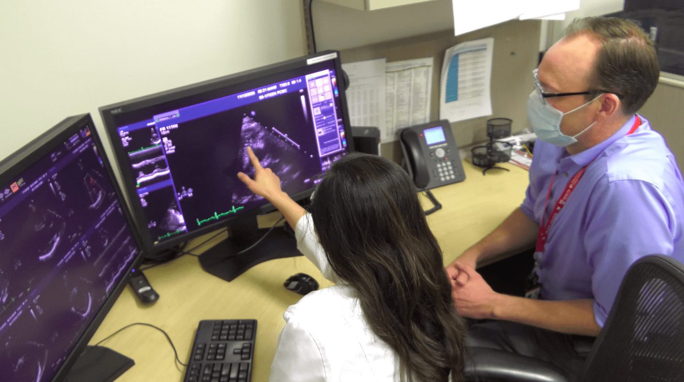 Pediatric cardiologist Dr. Dongngan Truong, of University of Utah Health and Intermountain Primary Children’s Hospital, consulting with a colleague.