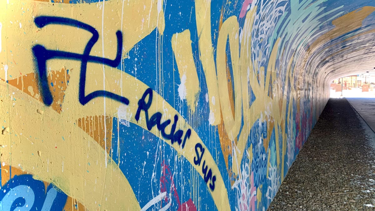 Racial slurs, swastikas, crude and vulgar language painted over what was once a colorful, positive mural in the pedestrian underpass at Newpark.
