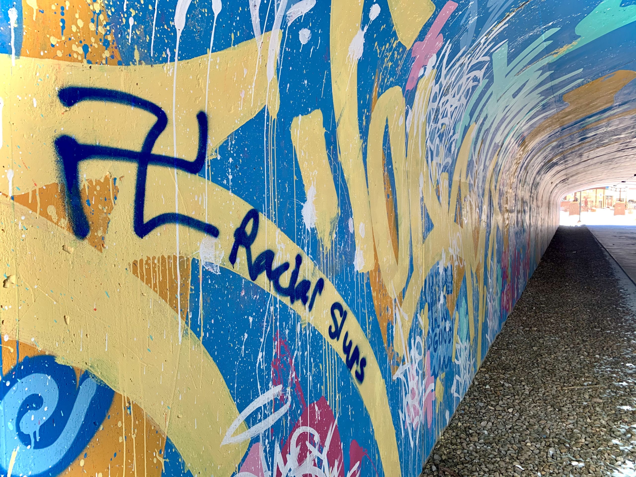 Racial slurs, swastikas, crude and vulgar language painted over what was once a colorful, positive mural in the pedestrian underpass at Newpark.