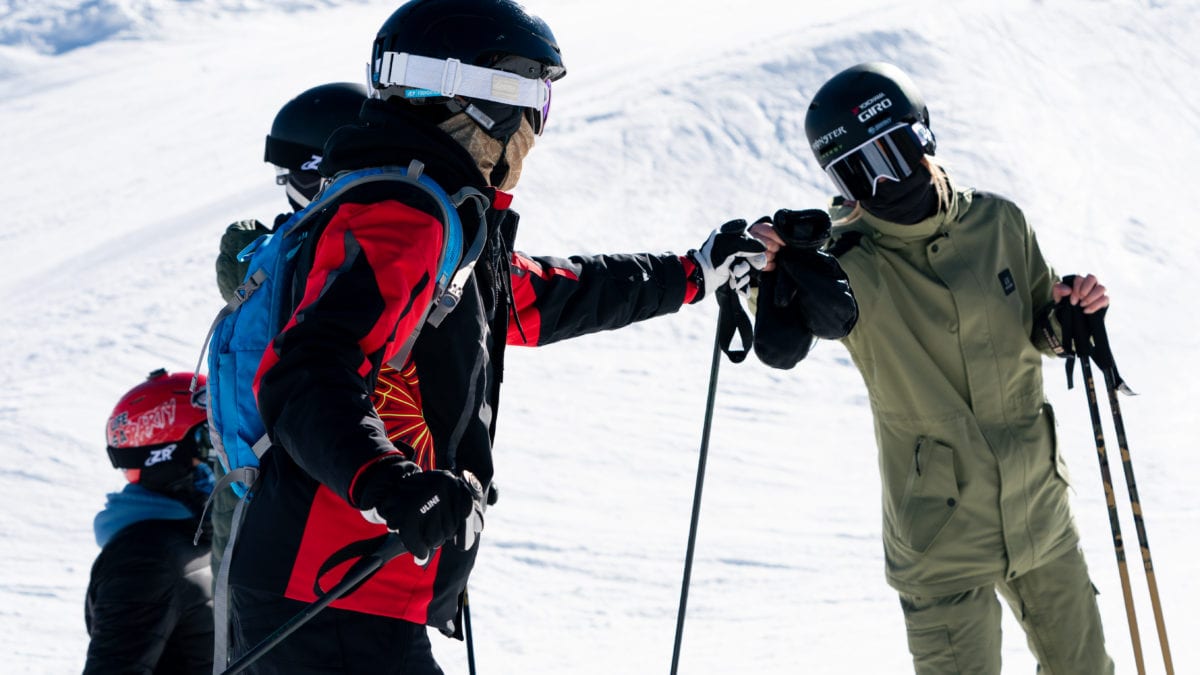 Brita Sigourney, on right, fist bumps a SOS Outreach youth. Sigourney is a freestyle skier in Park City, Utah. She won a silver medal in the superpipe at Winter X Games XV in 2011 and a bronze in 2012. She won a bronze medal in the 2018 Winter Olympics.
