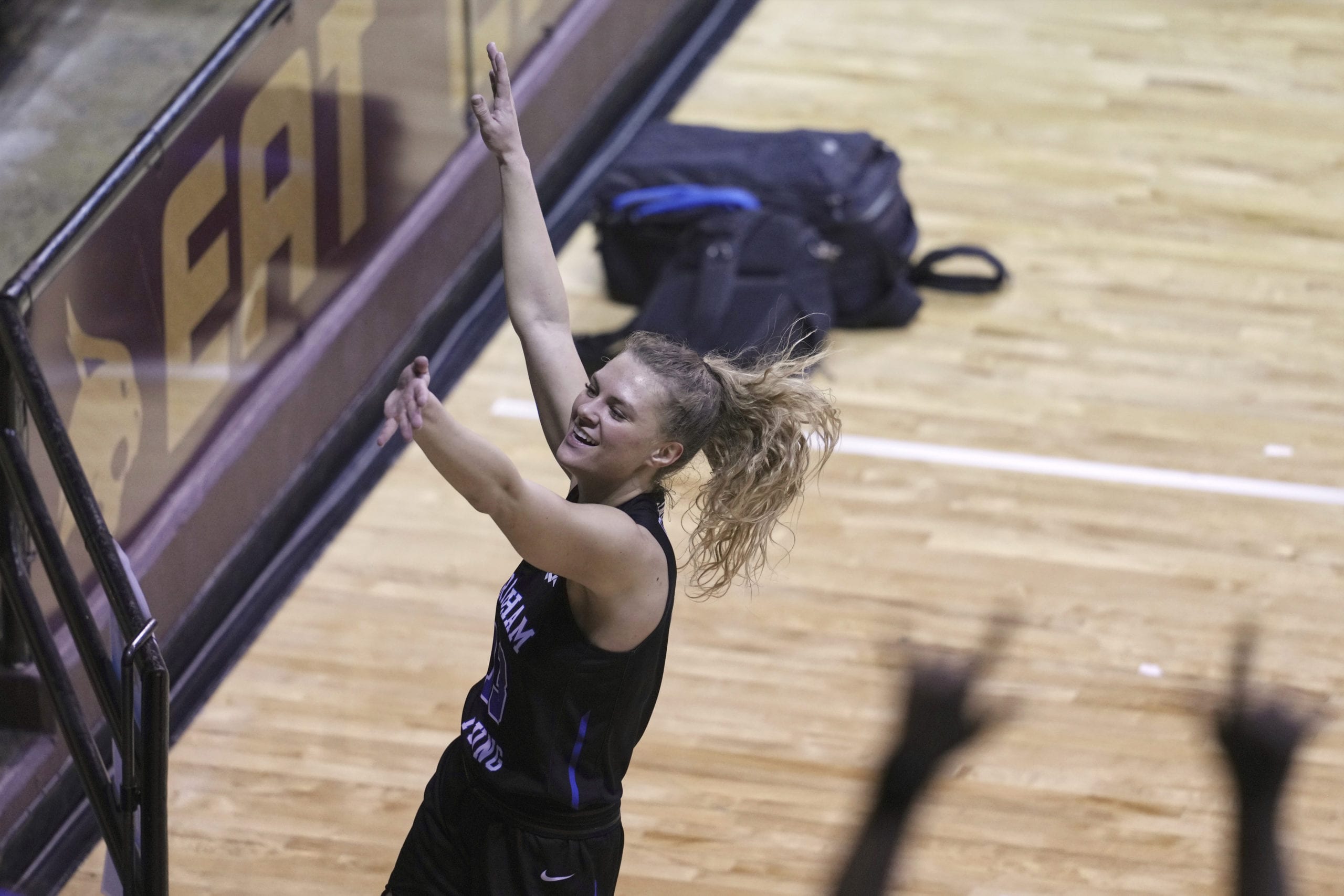 BYU's Paisley Harding (13) looks toward fans as she celebrates after BYU defeated Rutgers in a college basketball game in the first round of the women's NCAA tournament at the University Events Center in San Marcos, Texas, Monday, March 22, 2021. BYU defeated Rutgers 69-66.