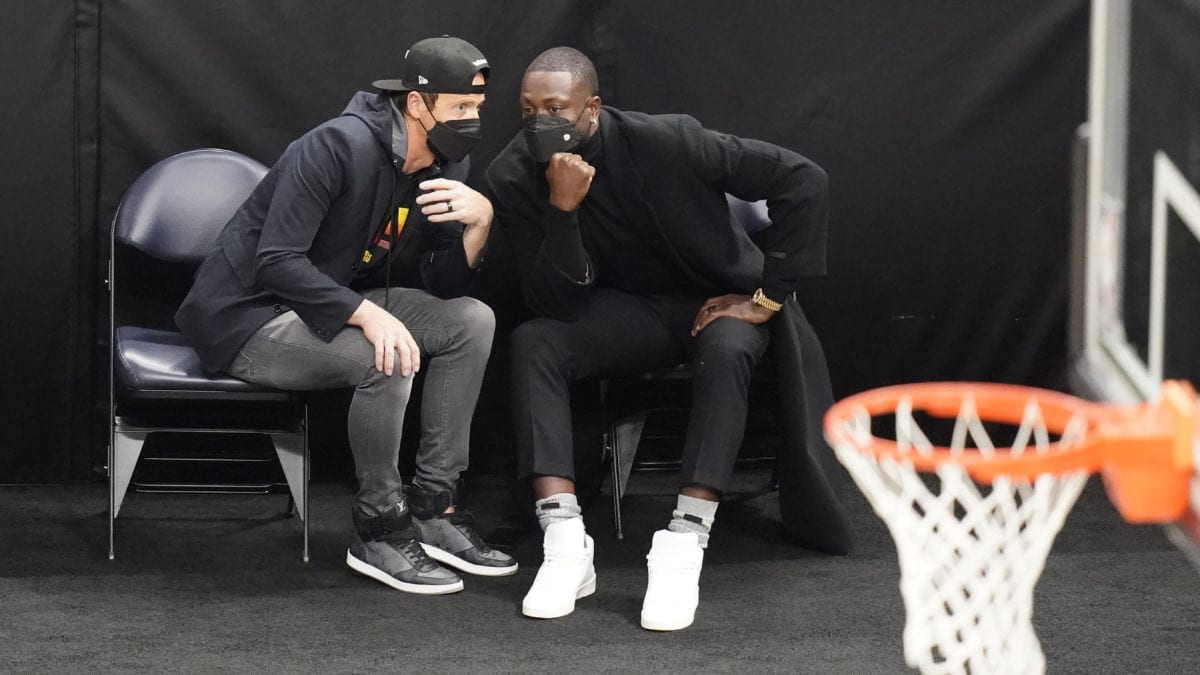 Ryan Smith, left, and Dwyane Wade, right, speak in the first half during an NBA basketball game between the Indiana Pacers and Utah Jazz, Friday, April 16.