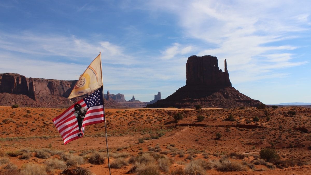 The Navajo Nation flag and the United States flag.