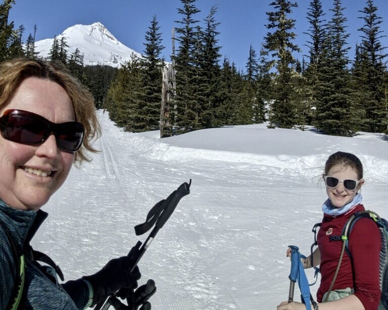 Michah Rigg (right), skiing with her mom Wyn, plans on getting the COVID vaccine.