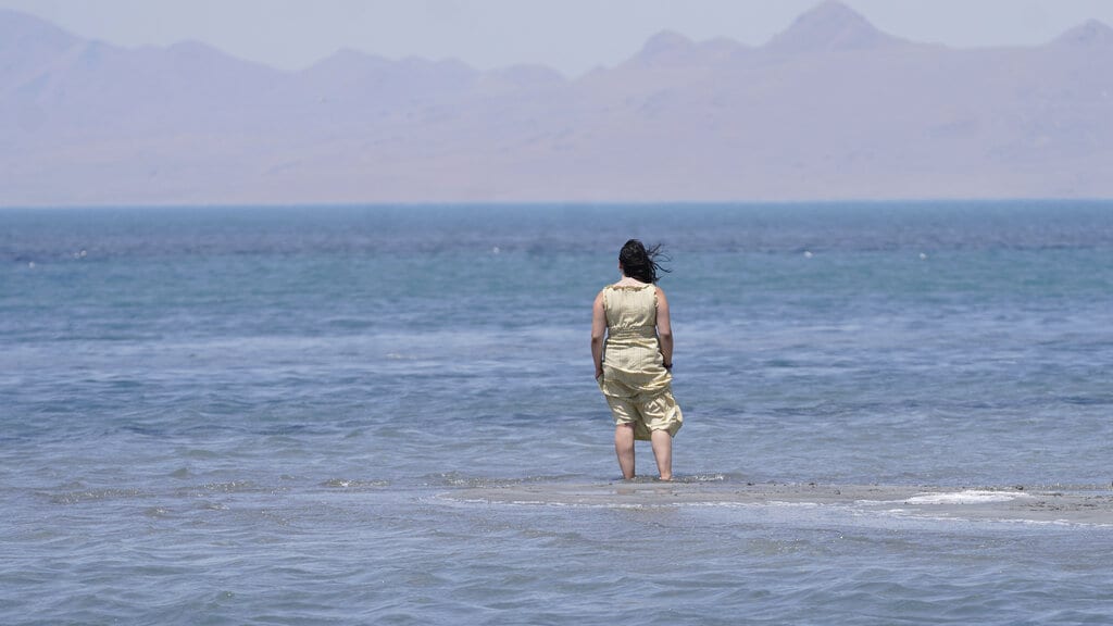 Amelia Gotbetter stands at the Great Salt Lake Tuesday, June 15, 2021, near Salt Lake City. Salt Lake City set another heat record Tuesday, June 15, 2021, and experienced its hottest day of the year as the state's record-breaking heat wave persists. Utah's capitol hit 104 degrees, breaking the previous heat record for that date of 103 degrees, according to information from the National Weather Service. On Monday, Salt Lake City hit 103 degrees to break a heat record for that date set nearly 50 years ago.