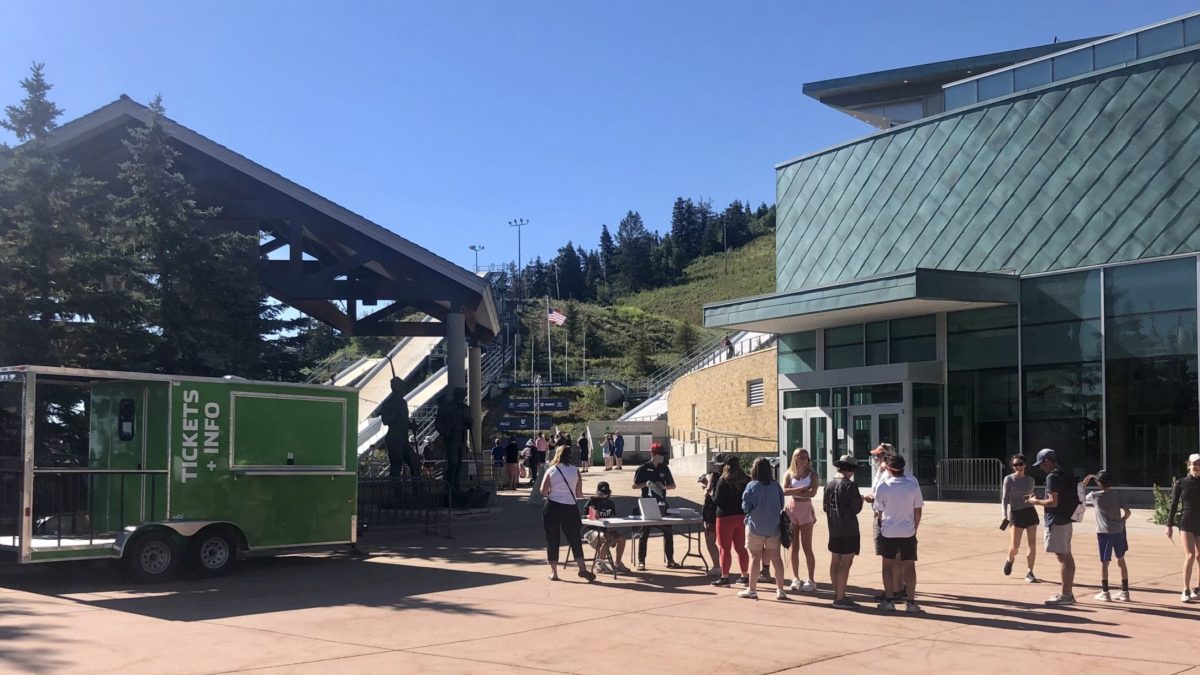 2018 Olympian Casey Larson (red cap answering guest questions behind the information desk) is working at the Utah Olympic Park when he's not training at the Utah Olympic Park, or perhaps it's the other way around. Illinois' Larson just won the ski jumping national championships on Sunday.