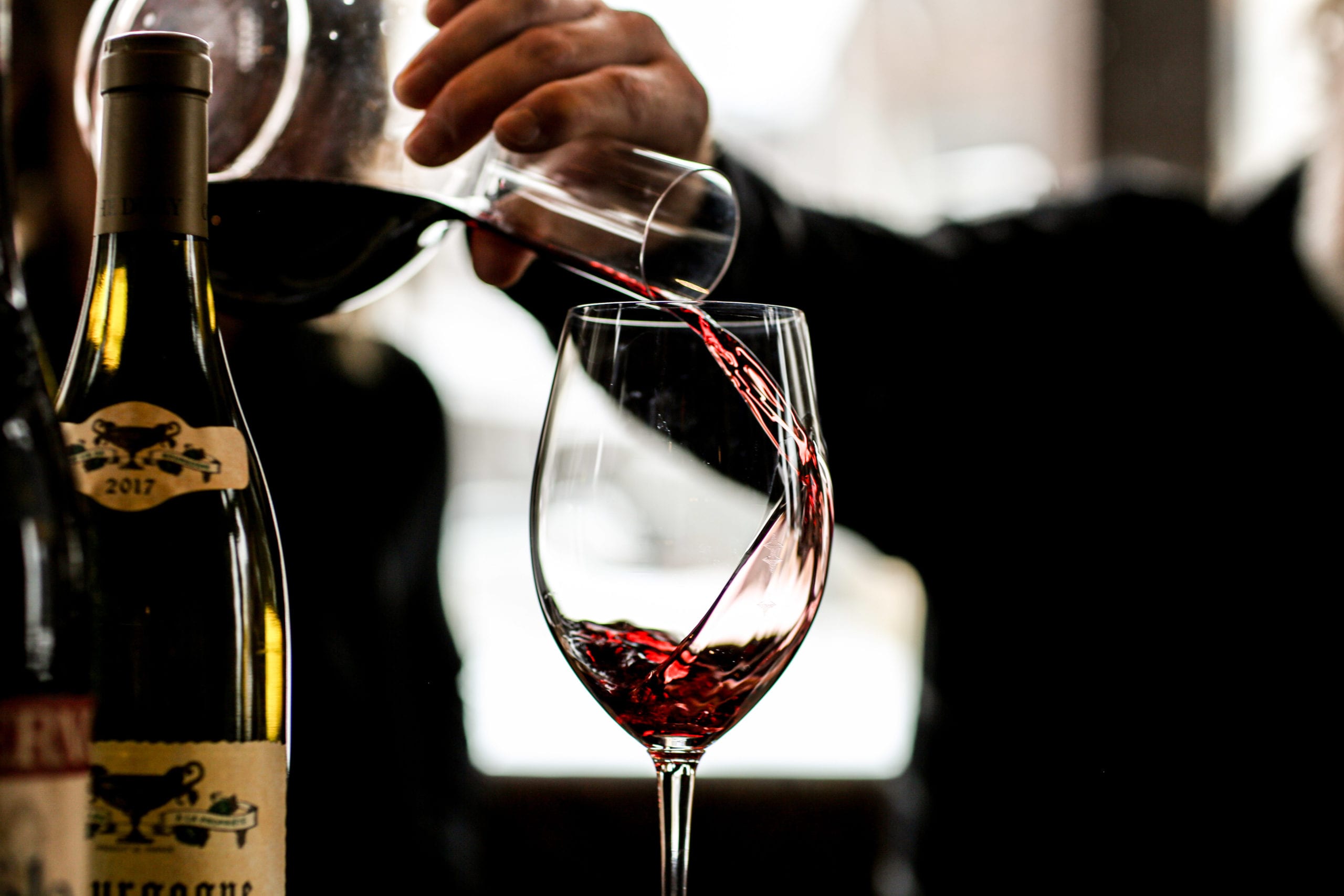 Jeff Roberts pours from a decanter.