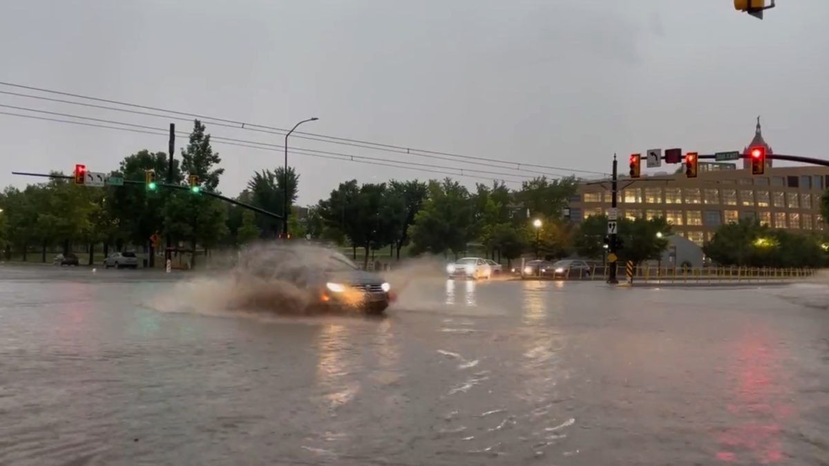 Cars driving through localized street flooding in downtown Salt Lake City near the Public Safety Building, August 1.