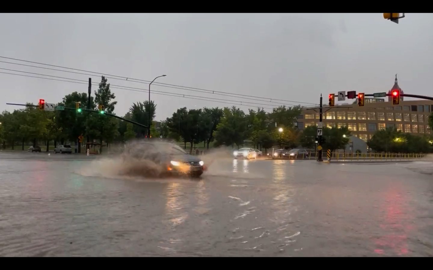 Cars driving through localized street flooding in downtown Salt Lake City near the Public Safety Building, August 1.