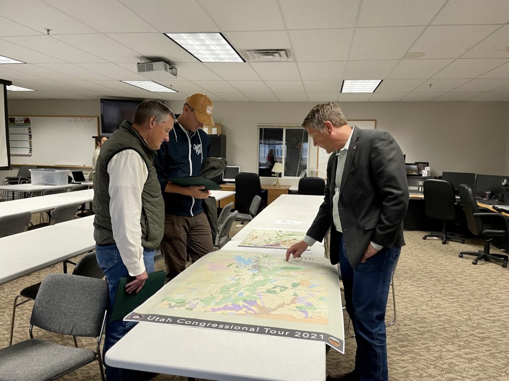 Reps. Westerman and Moore (left) are shown a map of the Upper Provo Watershed Restoration treatment areas.