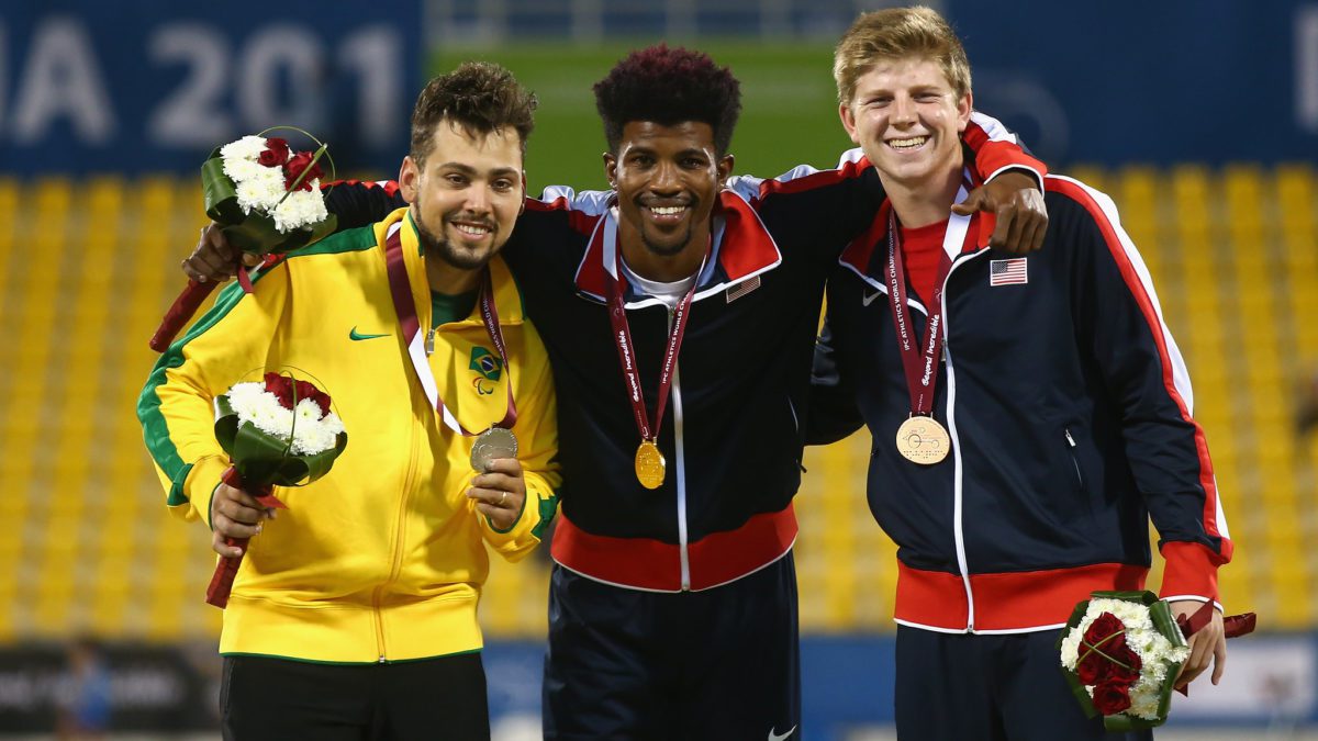 DOHA, QATAR - OCTOBER 25: Richard Browne of the United States poses with his gold, Alan Oliveira of Brazil silver and Hunter Woodhall of the United States bronze after the men's 200m T44 final during the Evening Session on Day Four of the IPC Athletics World Championships at Suhaim Bin Hamad Stadium on October 25, 2015 in Doha, Qatar.