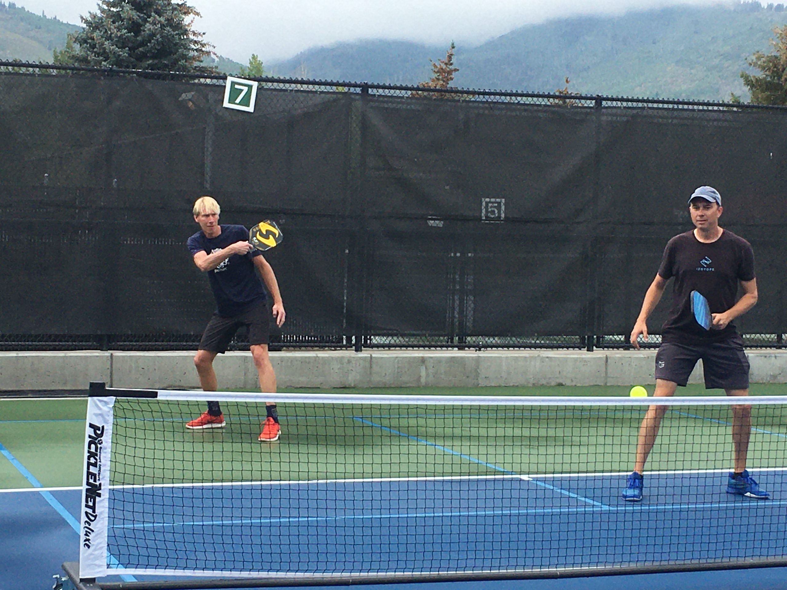 Mayor Andy Beerman (left) and local musician Jody Whitesides battle it out on the court at the Park City Pickleball Club's Marathon event.