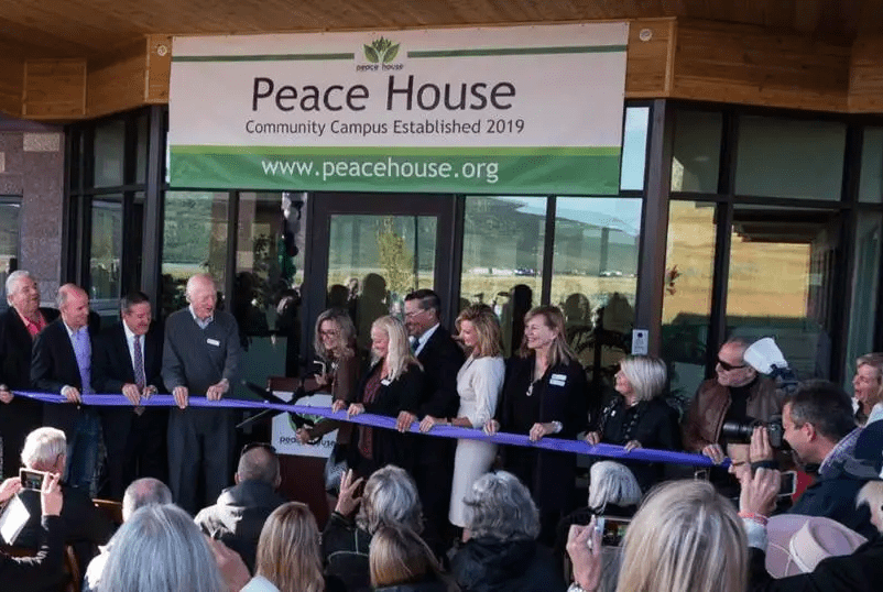 Executive Director, Kendra Wyckoff cuts ribbon at the opening of the new Peace House Community Campus on September 21, 2019.