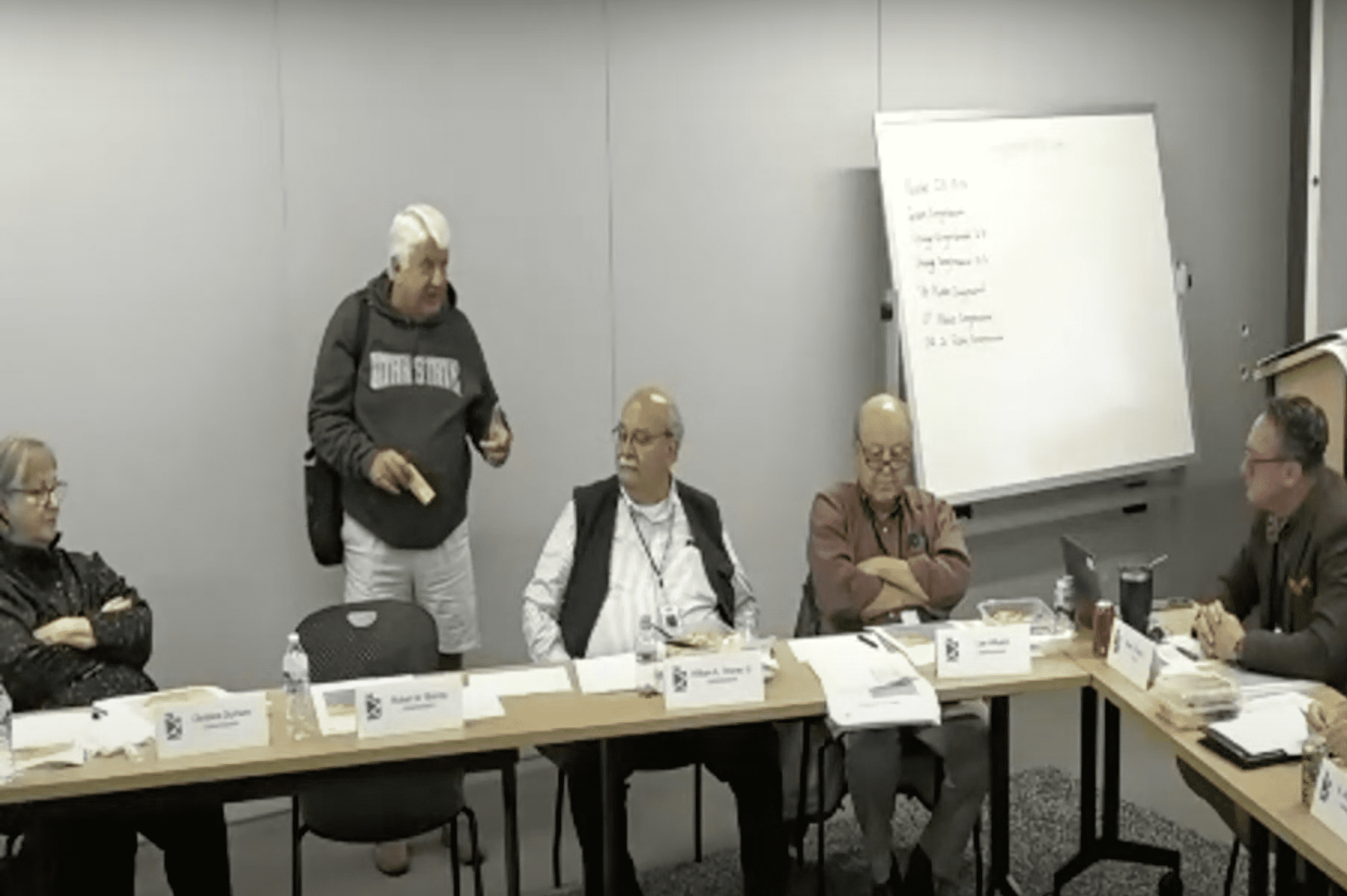 Former congressman Rob Bishop, in a hoodie, shorts and sandals, walking out of the committee meeting on Monday.