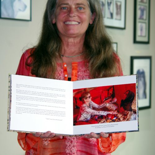 Margot Wholey holding her a self-published first book on the Comcaac Project in Cmiique Iitom.