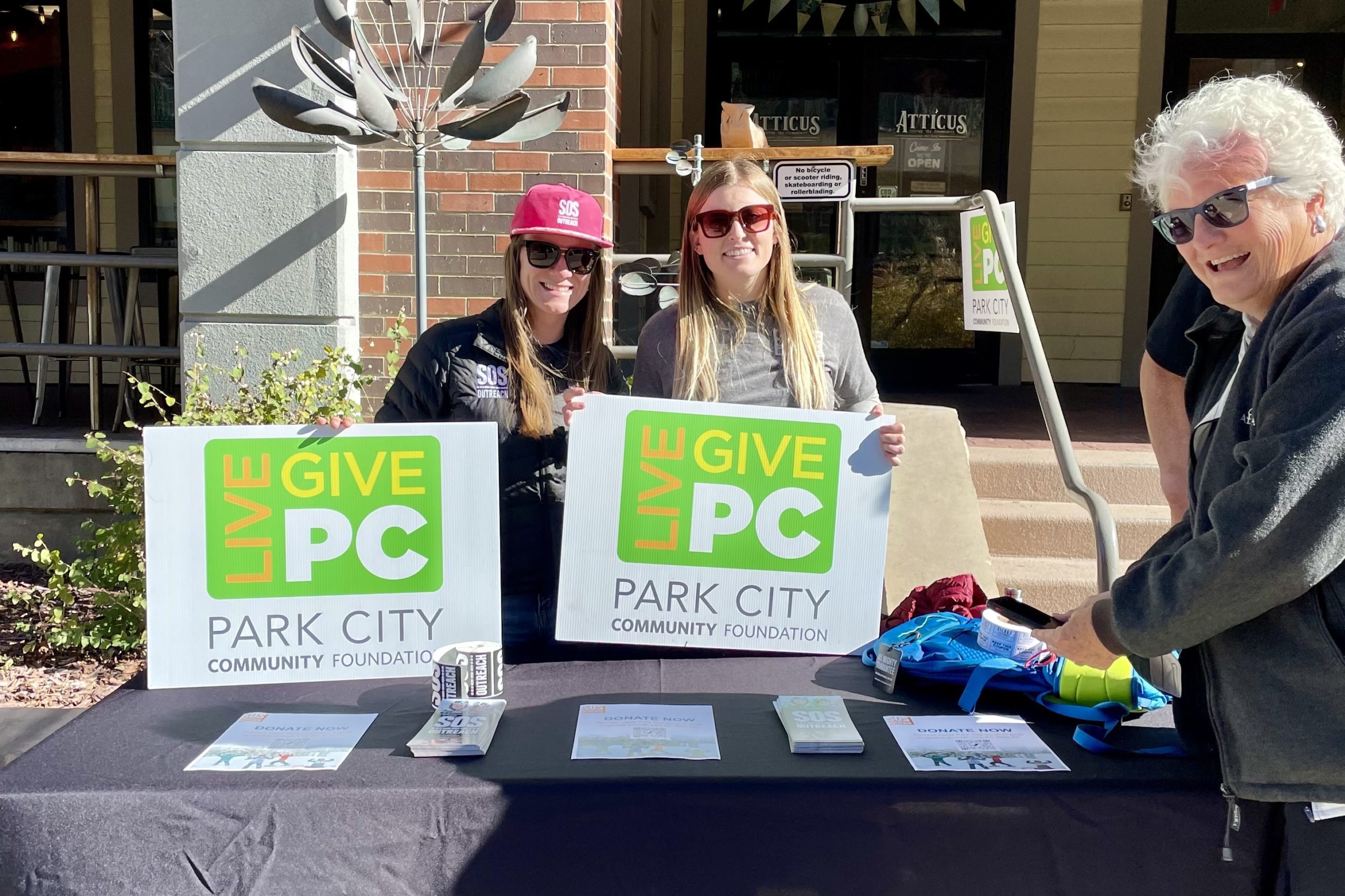 Members of SOS Outreach outside of Atticus Coffee on Main Street on Friday.