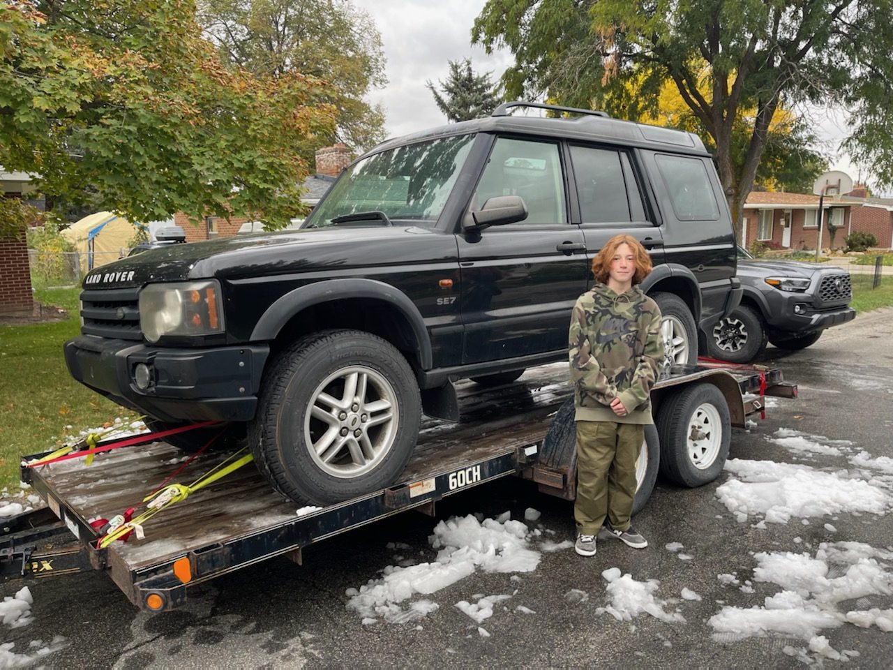 Tommy Brown, with the Land Rover he was able to purchase with the funds from his business last year. His parents matched his contribution.