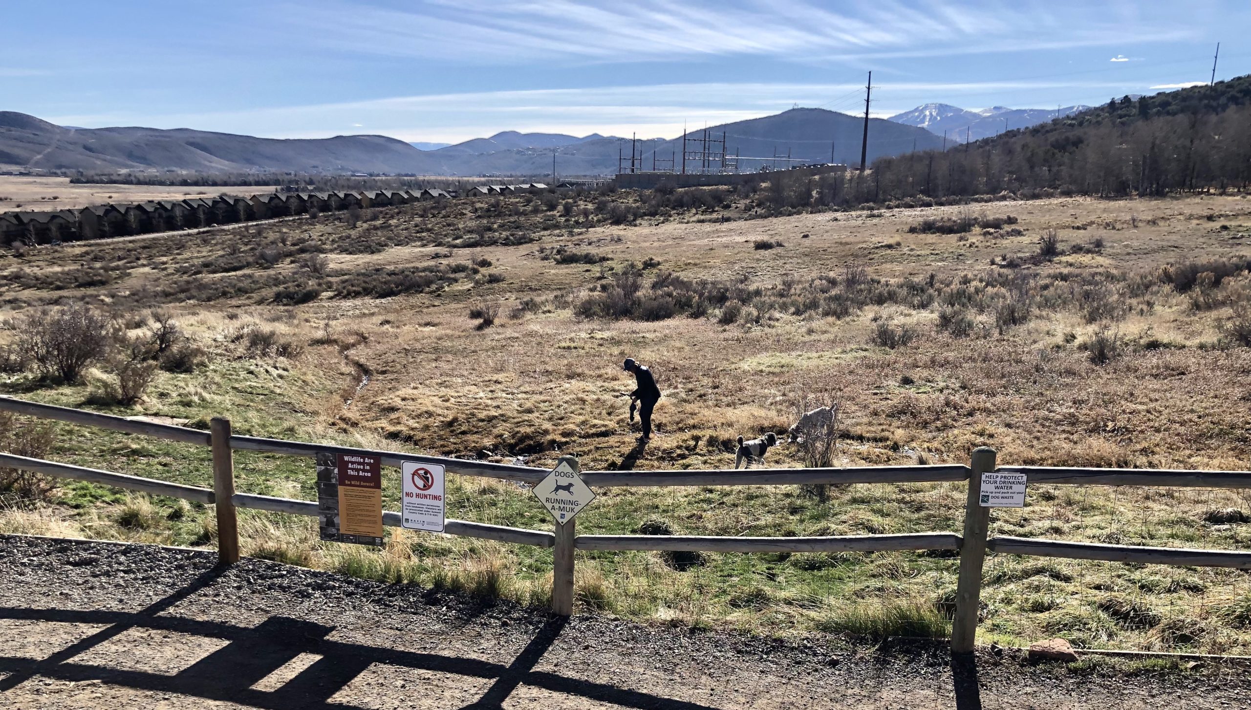 Sassy and Goose's humans, Stacey and Scott Johnson (Scott is just out of the photo) cleaning up and searching for the Golden Poop at the Basin Recreation community volunteer clean-up day at the Run-A=Muk dog Park in Summit County. UT. Stacey found the Golden Poop last year.