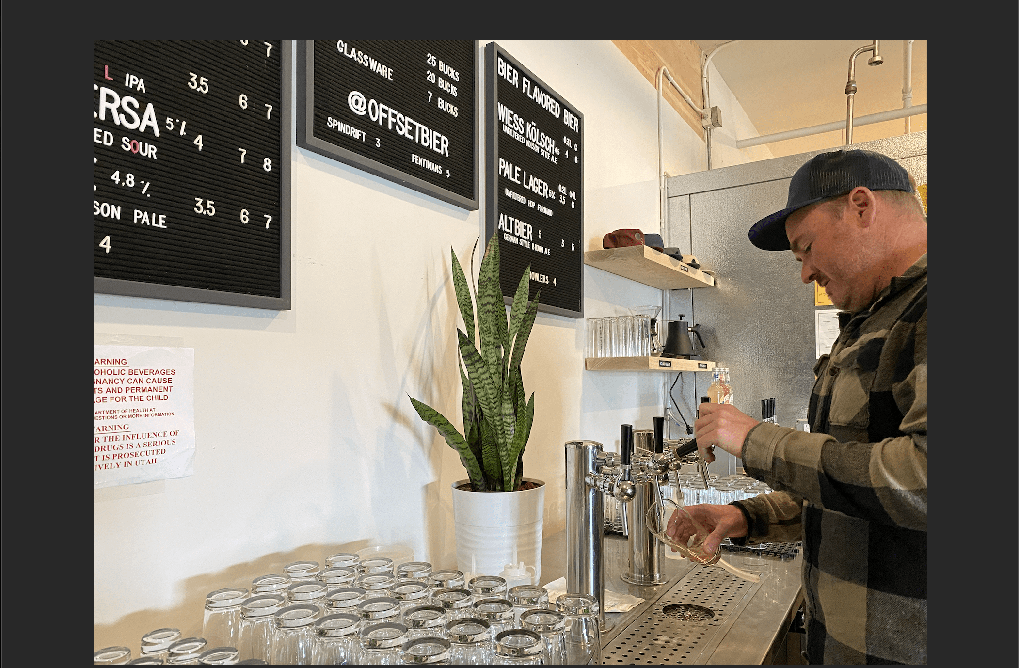 Offset Bier co-owner Conor Brown, pours a Kolsch with a hefty head.