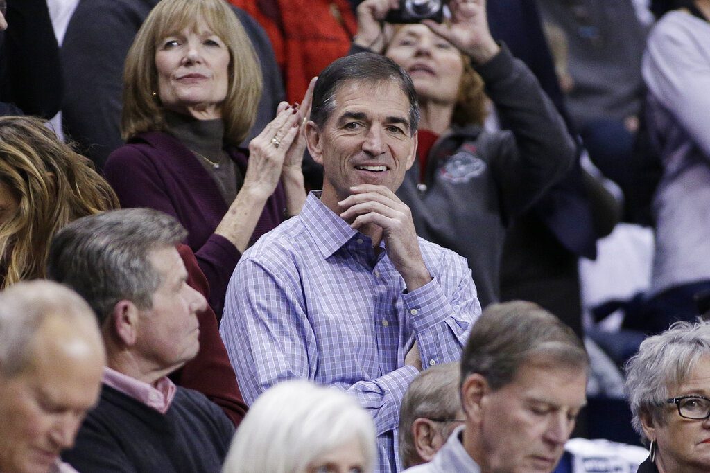 Retired NBA player and Gonzaga alumnus John Stockton, center, looks on before an NCAA college basketball game between Gonzaga and Washington in Spokane, Wash., Wednesday, Dec. 7, 2016.