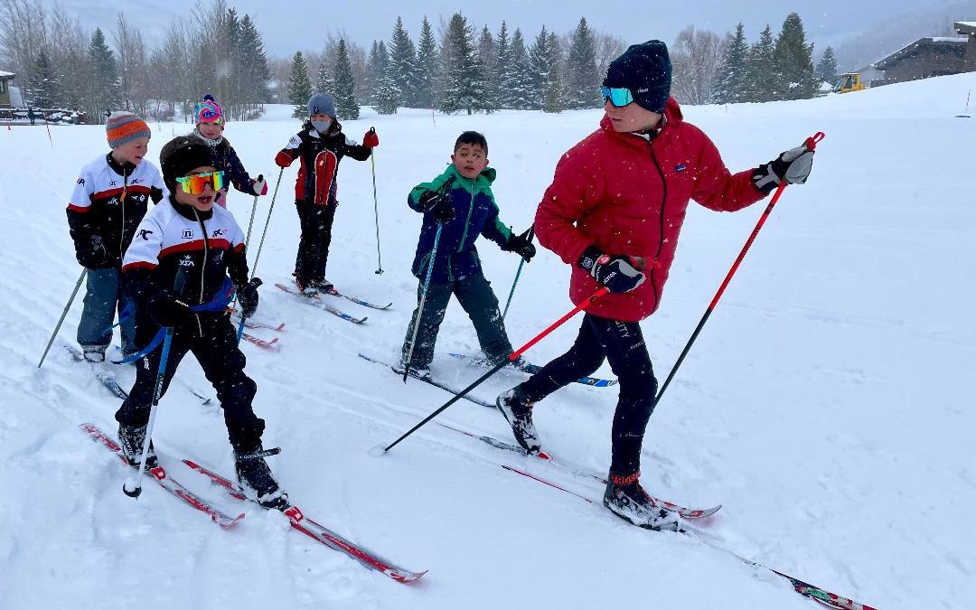 Ian Carmack (right) mentoring five younger cross country ski athletes at White Pine Nordic Center in Park City Ski and Snowboard's Kickers and Gliders program.