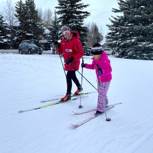 Bailey Carmack mentoring a younger cross country skier.