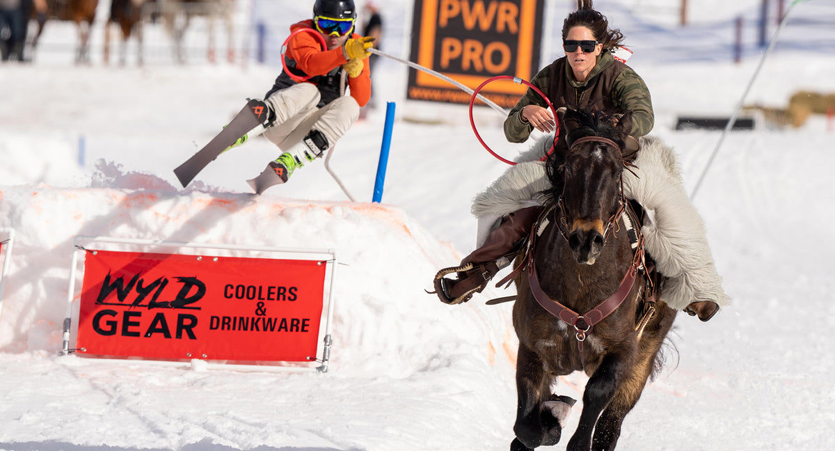 Ski joring is an action-packed competition in which a horse and rider pull a skier at a fast pace through a course that includes gates, jumps, and rings.