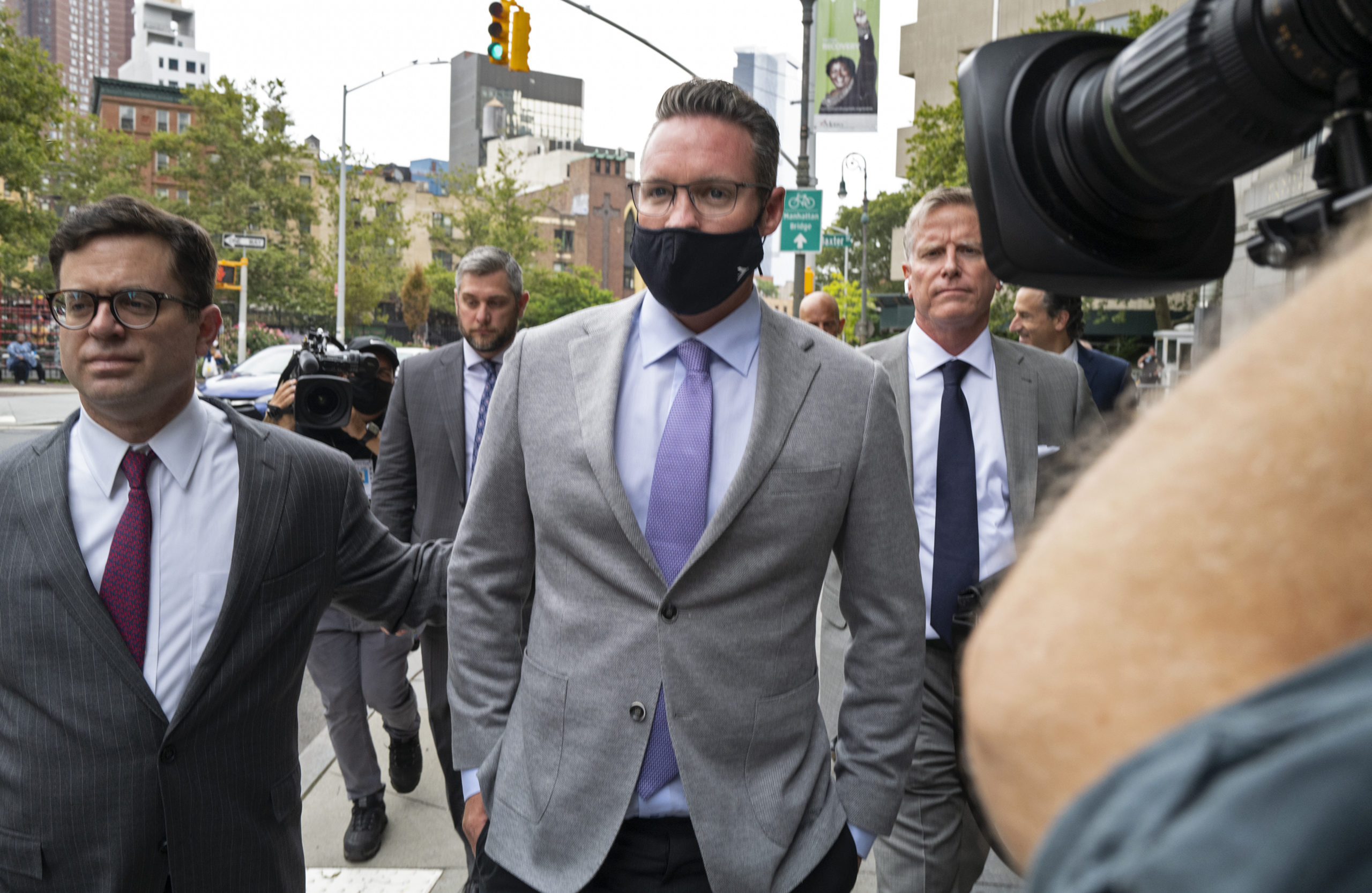 Nikola founder Trevor Milton, center, leaves a federal courthouse in New York on July 29, 2021, after being charged with three counts of criminal fraud for lying to bolster stock sales of the electric vehicle start-up Nikola.