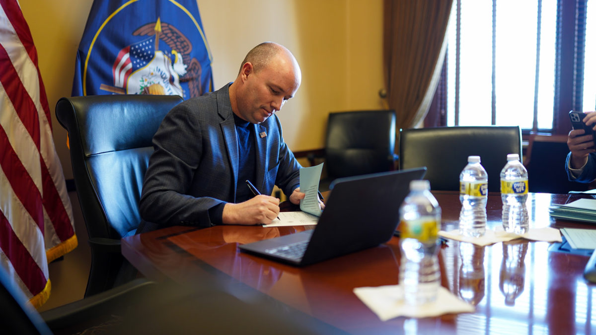 Utah Gov. Spencer Cox signing a bill on Monday that does not relate to transgender athletes.
