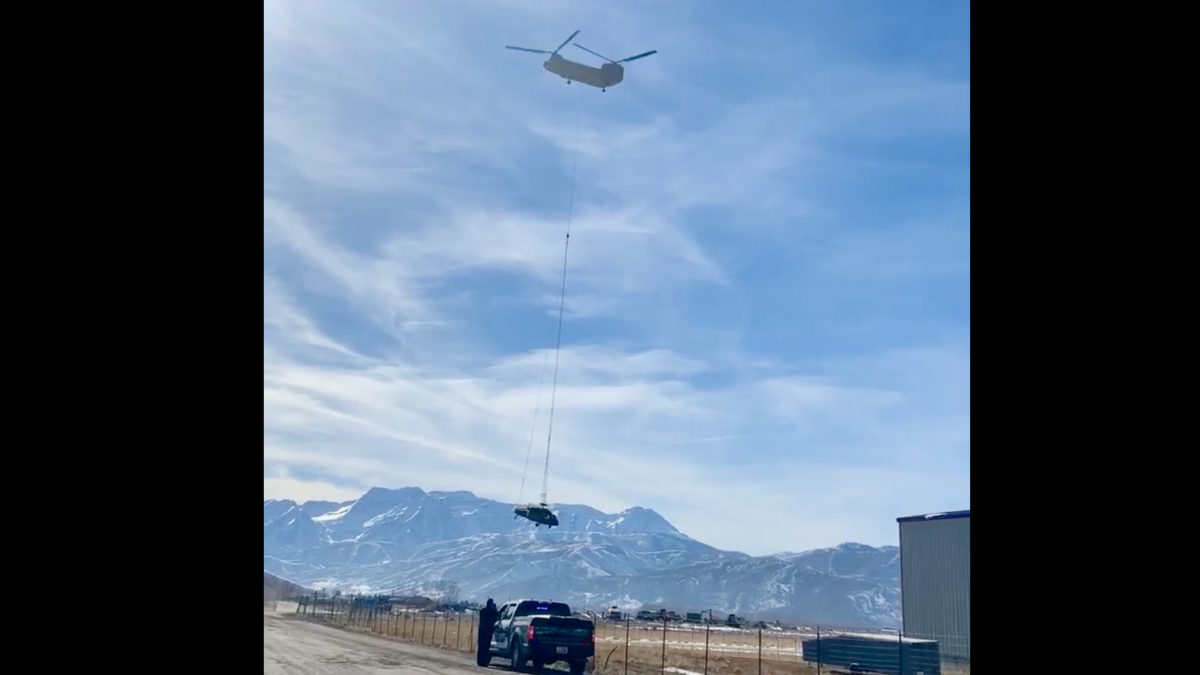 A Chinook helicopter from the Army National Guard transporting one of the UH-60 Black Hawks that crashed near Snowbird last week.