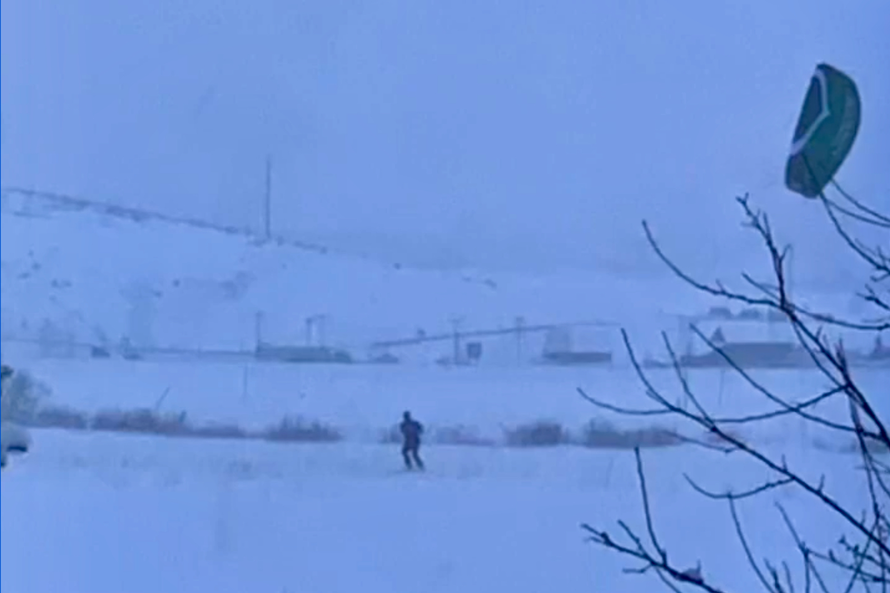 A kite skier attacking the dawn of a long-awaited powder day.