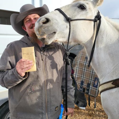 Dennis Wright and his horse, Helga, enjoying their winnings after a team roping event.