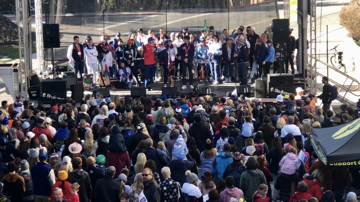 66 past and present Winter/Summer/Olympians/Paralympians on stage on Main St. Park City after the Youth Sports Alliance (YSA) Parade. Center stage are YSA Beijing Olympians Jared Shumate, Ashley Farquharson, and Casey Dawson, the three were the Parade Grand Marshals.