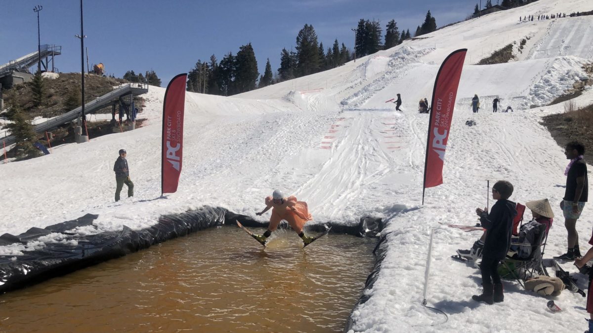Josie Johnson, usually a ski jumper, was a pond skimmer on Sunday in her a costume, a Bad Prom Dress, at the Utah Olympic Park for the Park City Ski and Snowboard's Skimeister.