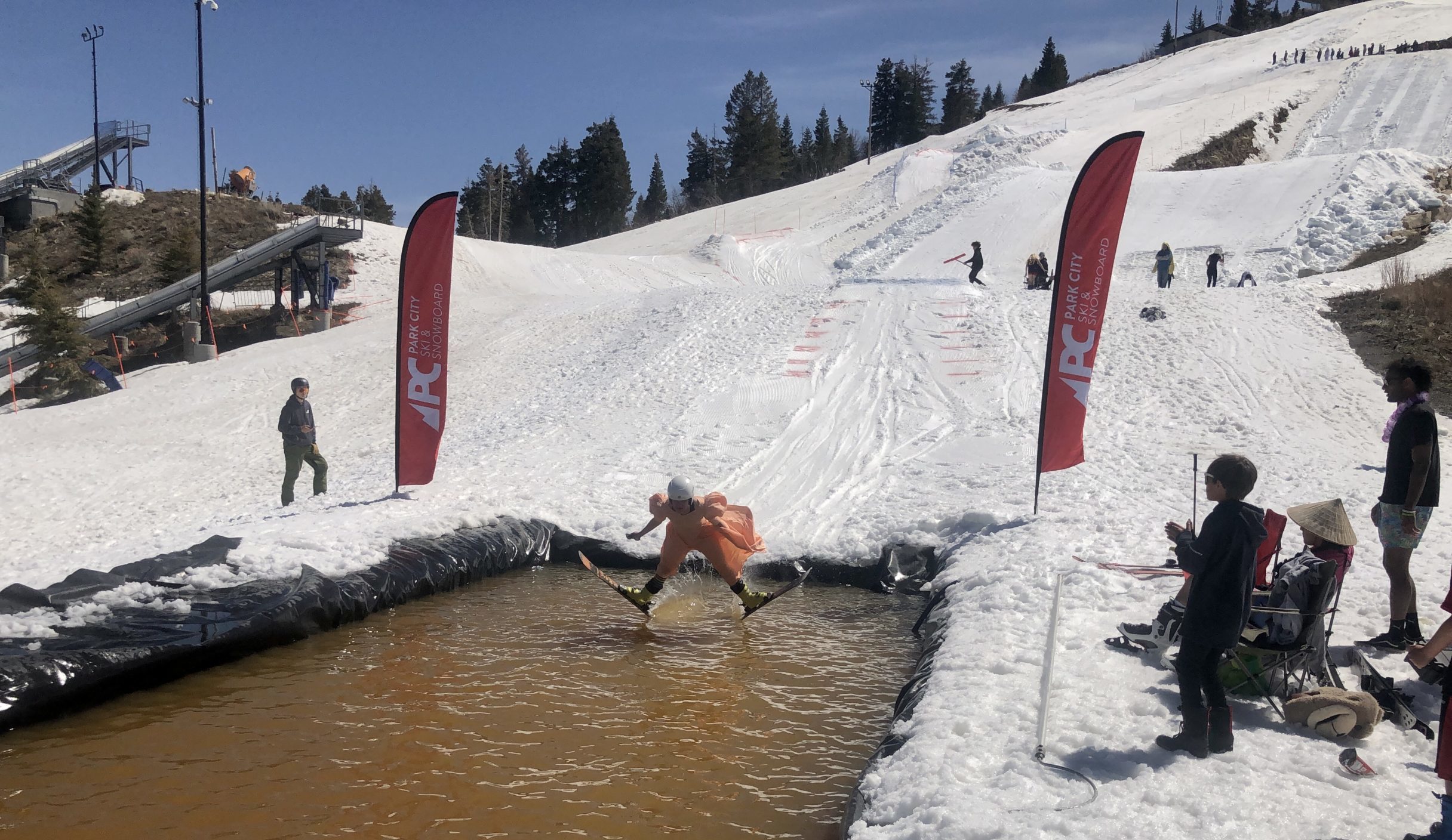 Josie Johnson, usually a ski jumper, was a pond skimmer on Sunday in her a costume, a Bad Prom Dress, at the Utah Olympic Park for the Park City Ski and Snowboard's Skimeister.