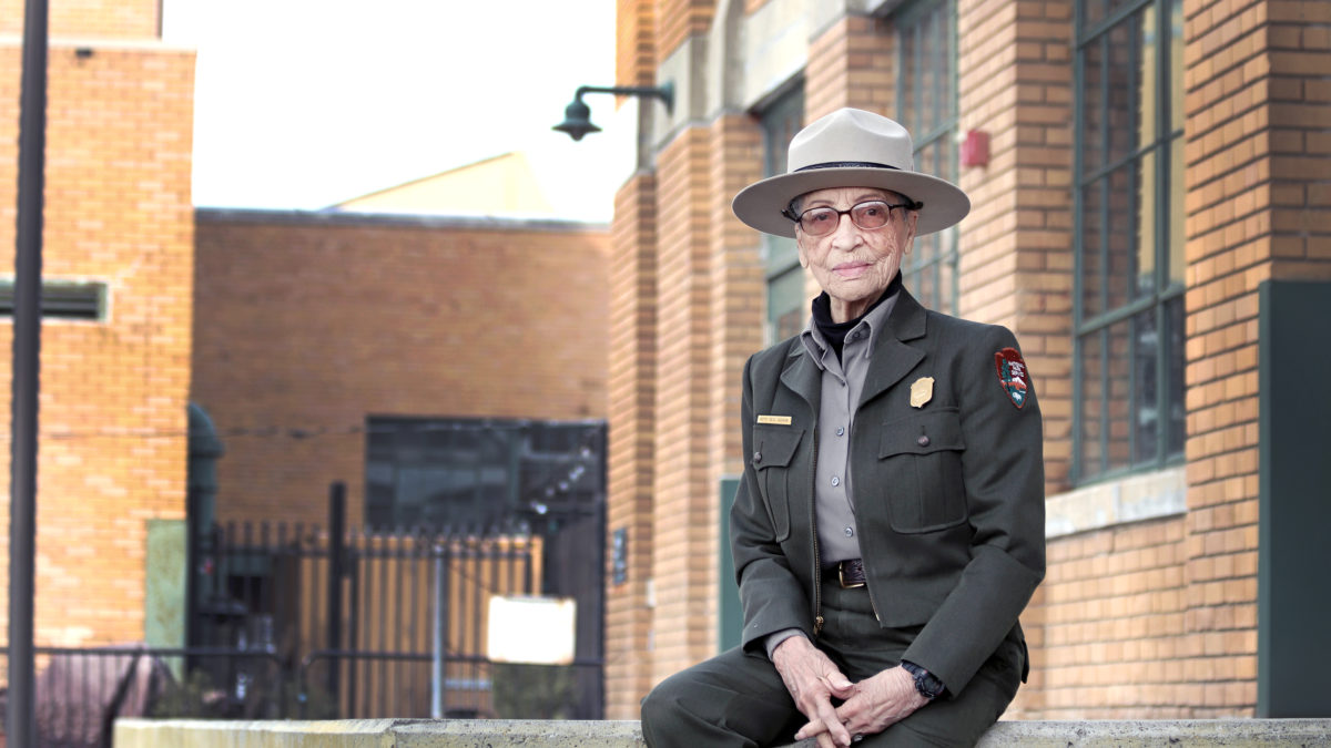 Ranger Betty Reid Soskin sits in front of the Rosie the Riveter Visitor Center.