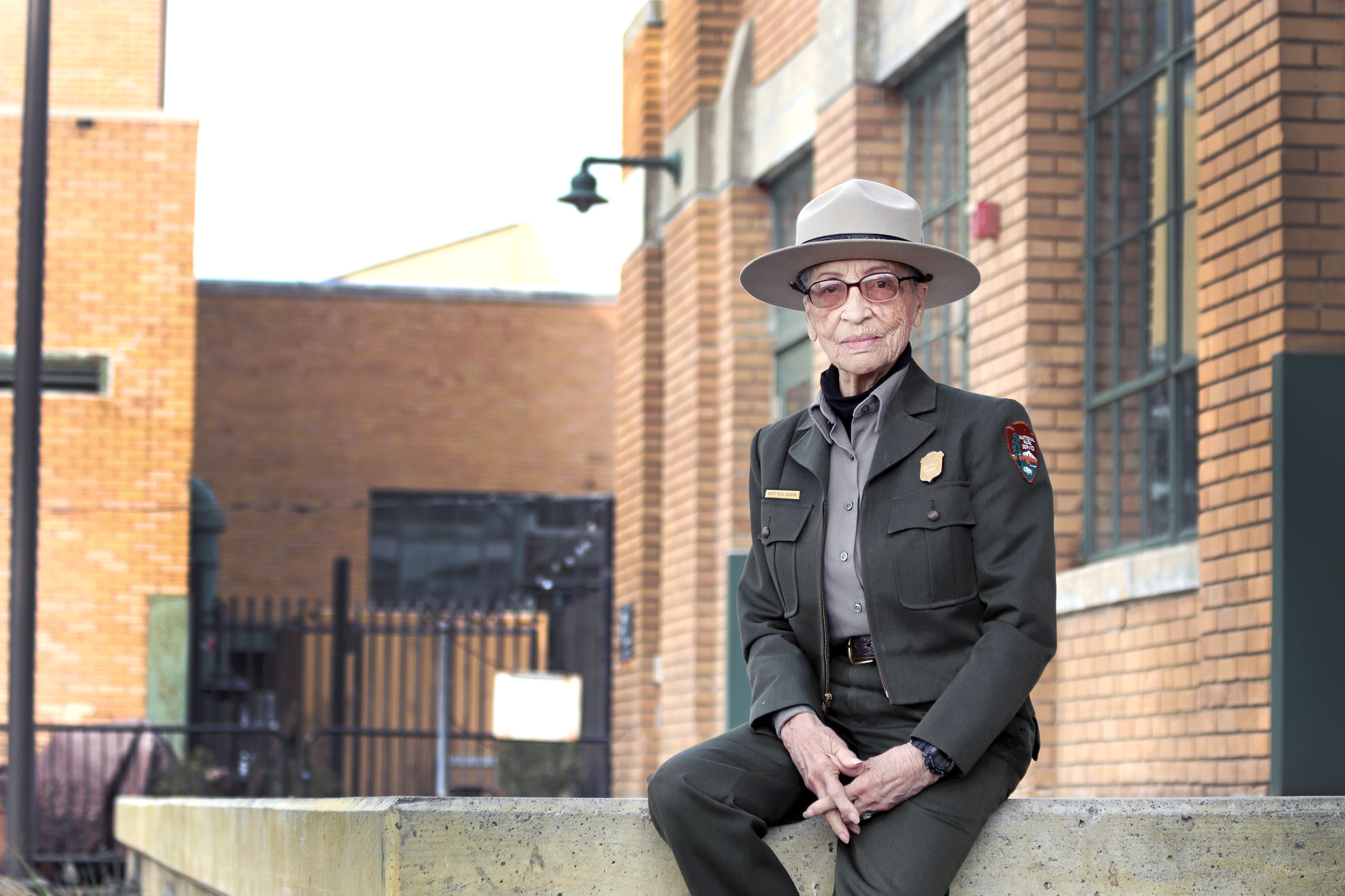 Ranger Betty Reid Soskin sits in front of the Rosie the Riveter Visitor Center.