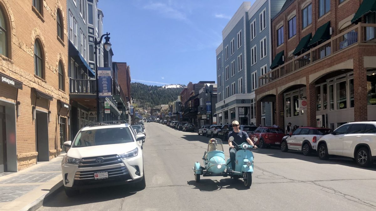 Soto in the vintage Vespa with his owner, Chip, on Main St, Park City.