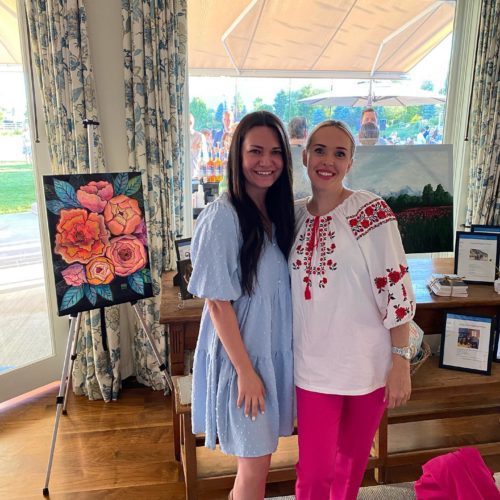 Ukrainian Artists Alyona Balser and Lana Miroshnichenko next to their paintings Photo: Lindsey Leavitt