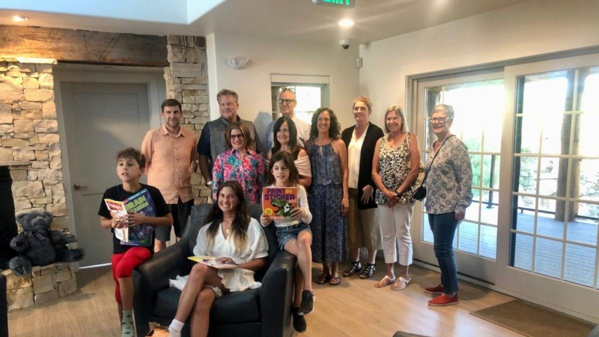 Ali Maguga (seated, centered in white) and just some of her many friends, family, and fans, including members of the Park City Rotary Club, at the Beano Solomon Summit County Children's Justice Center.