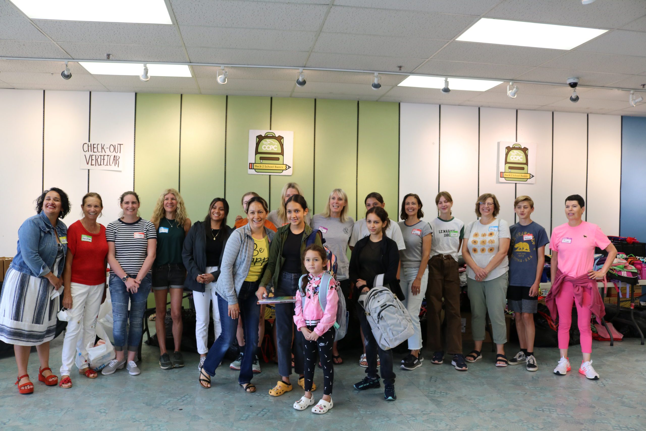 Camila, Alexa, Romina, and mom Rafaela pose with the Back 2 School Basics volunteers after picking out brand new school supplies.